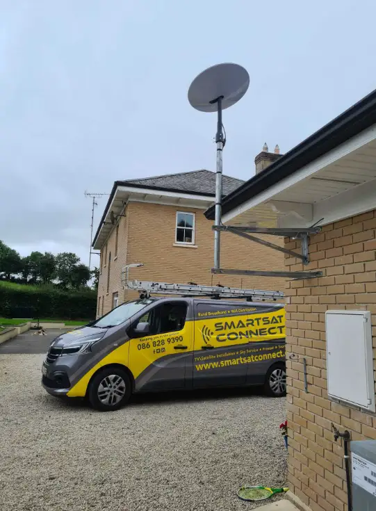 starlink antenna installed on a house with a Smart Sat Connect van in the background